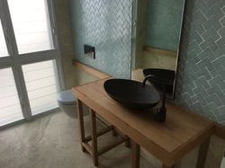 A New Bathroom With a Toilet, Vanity, Basin and a Window — Reed Plumbing Industries in Mackay, QLD