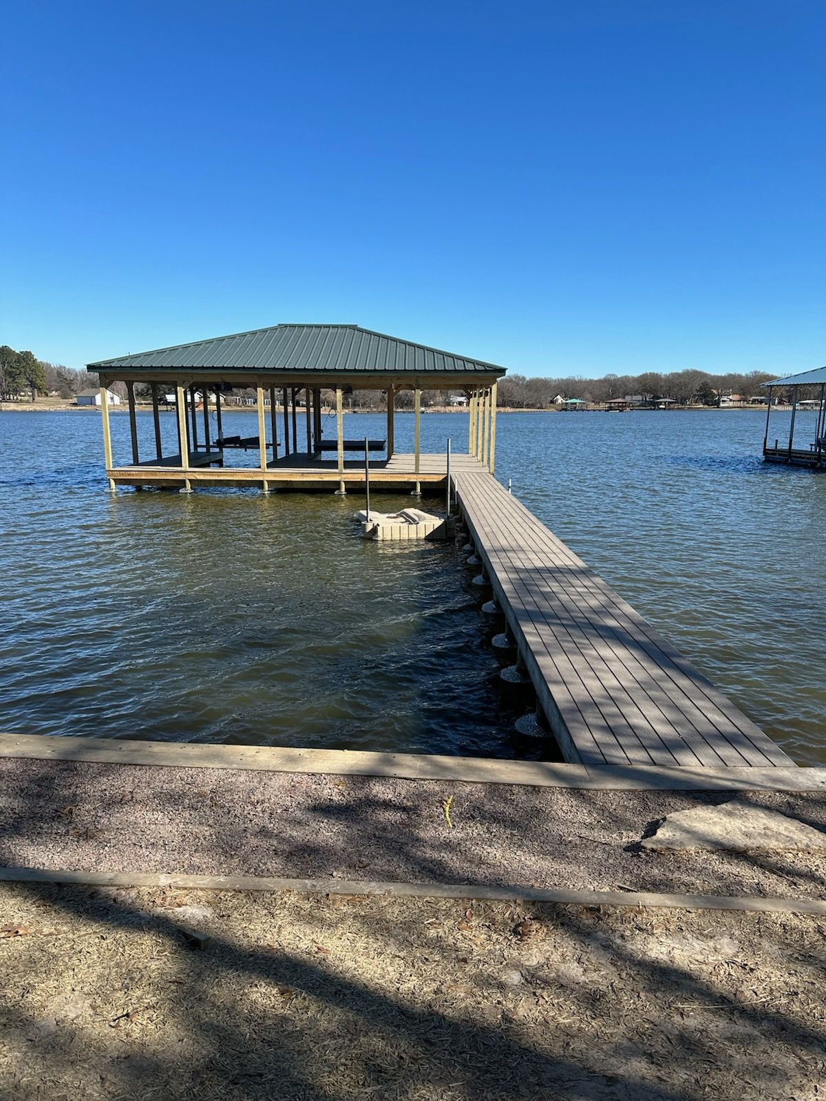 There is a dock in the middle of the water.