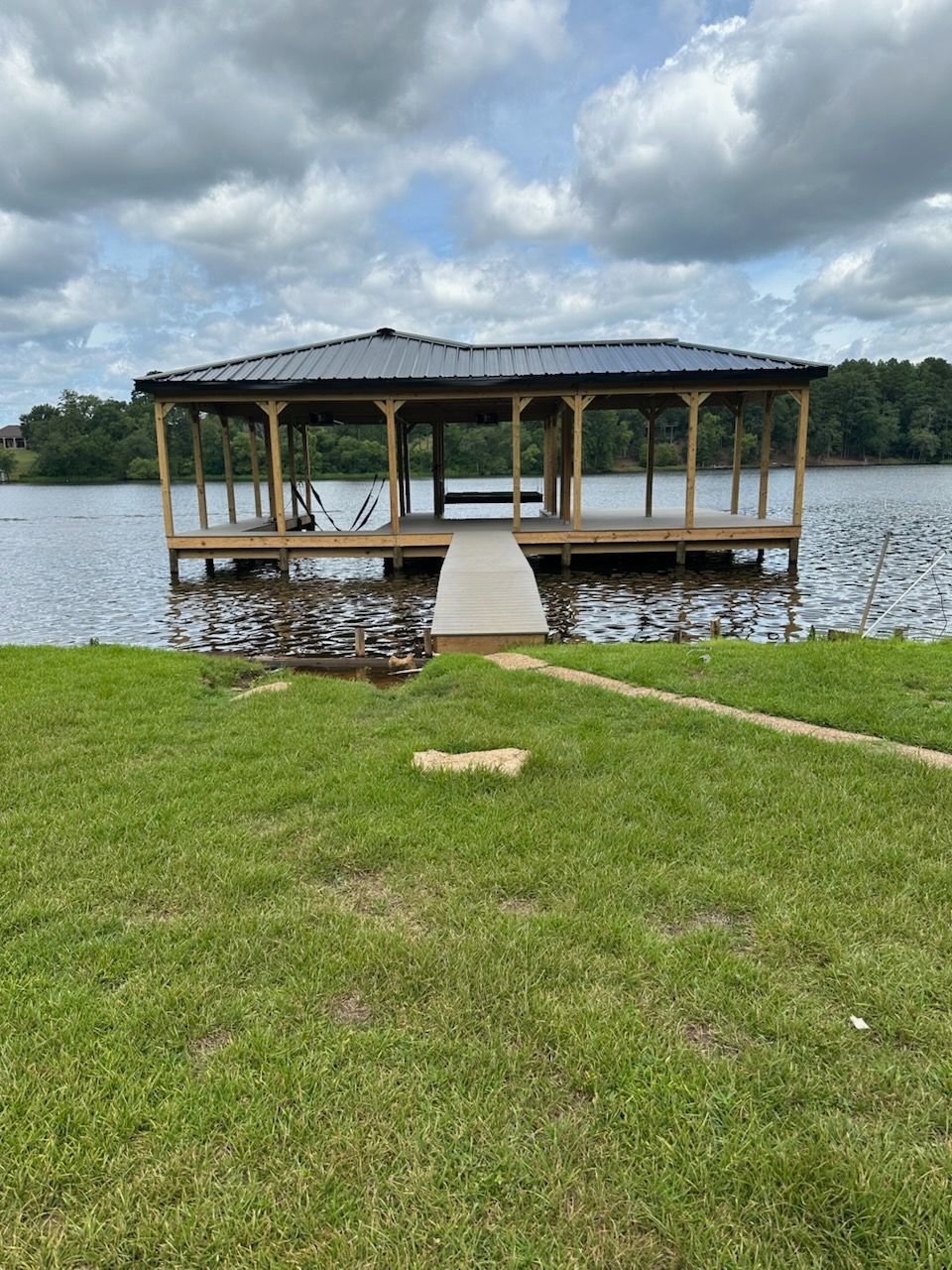 A dock is sitting on the shore of a lake.