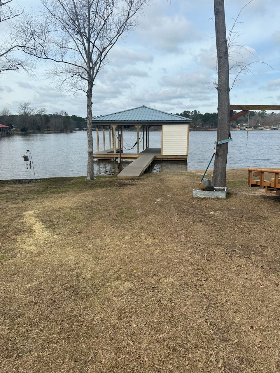 There is a dock in the middle of a lake.