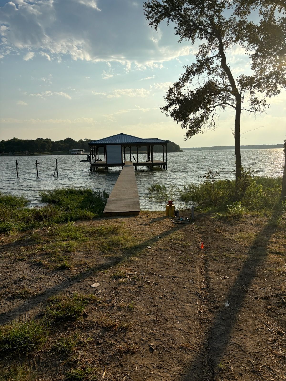 There is a dock in the middle of a lake.