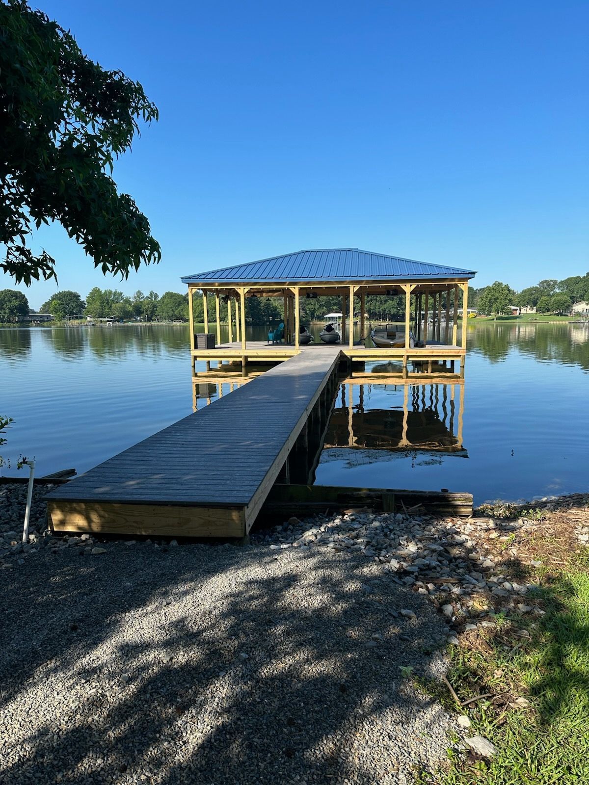 A wooden dock is sitting on the shore of a lake.