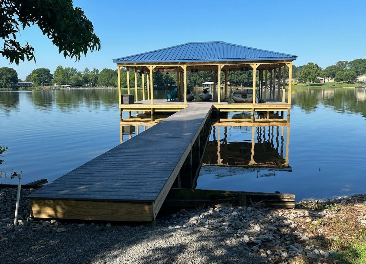 A dock on a lake with a blue roof