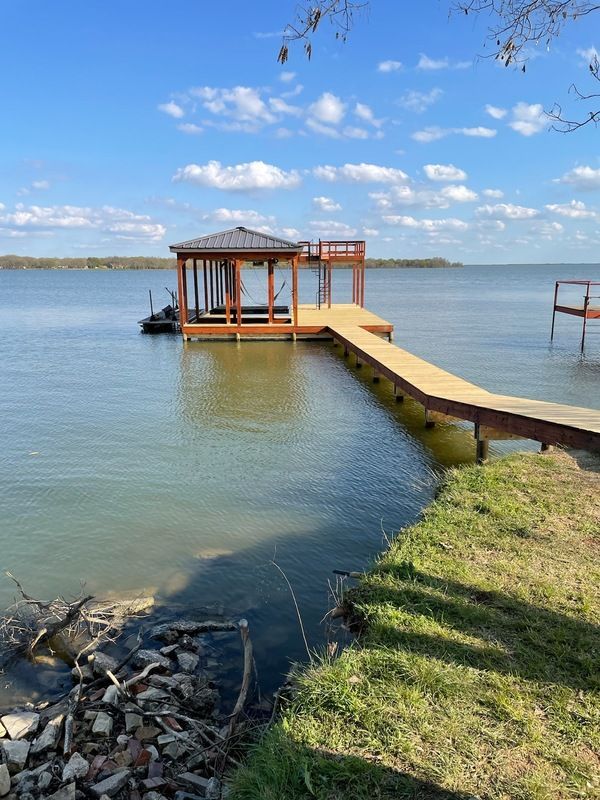 A large body of water with a dock in the middle of it.