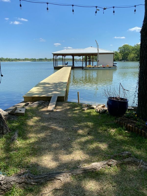 There is a dock in the middle of a lake.