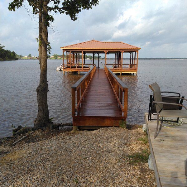 A wooden dock with a gazebo on top of it