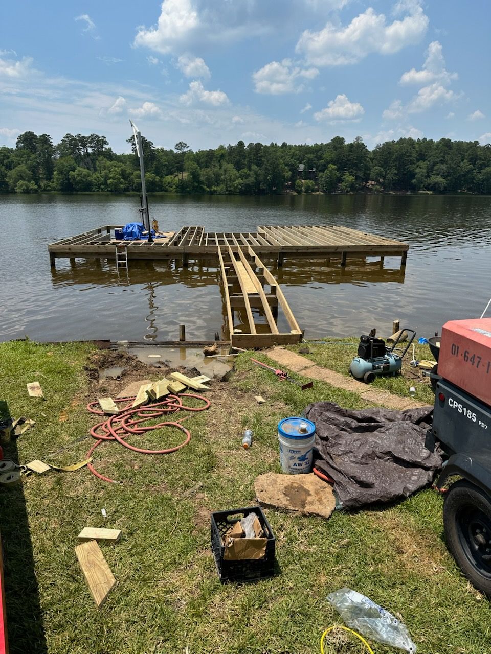 A dock is being built on the shore of a lake.