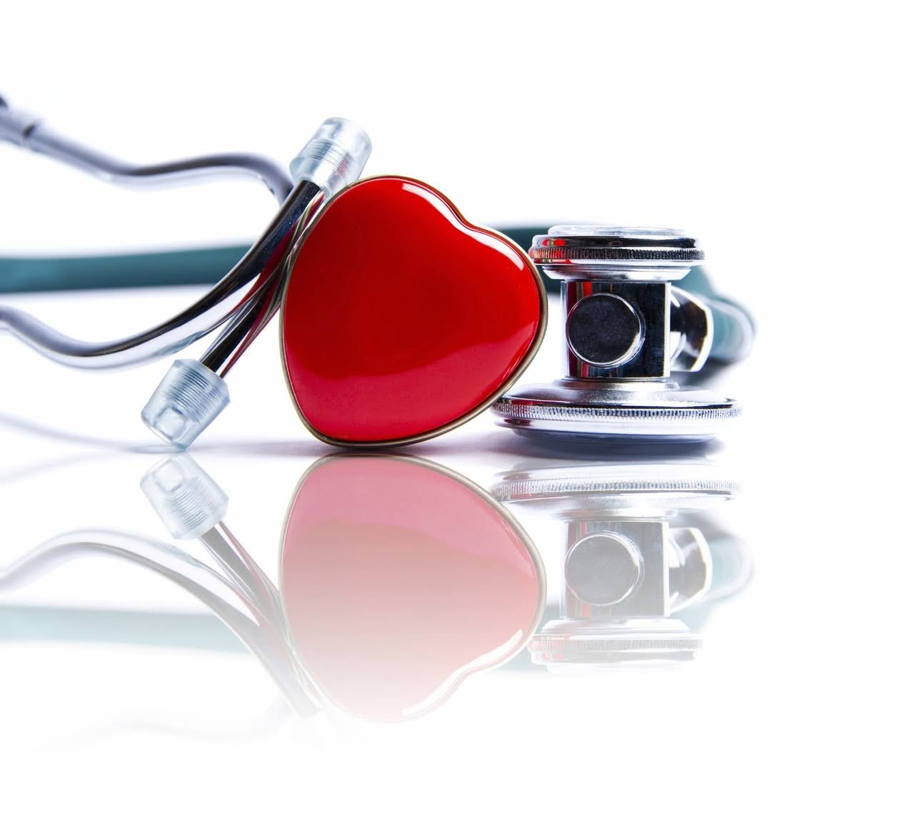 Red heart and stethoscope on white background.