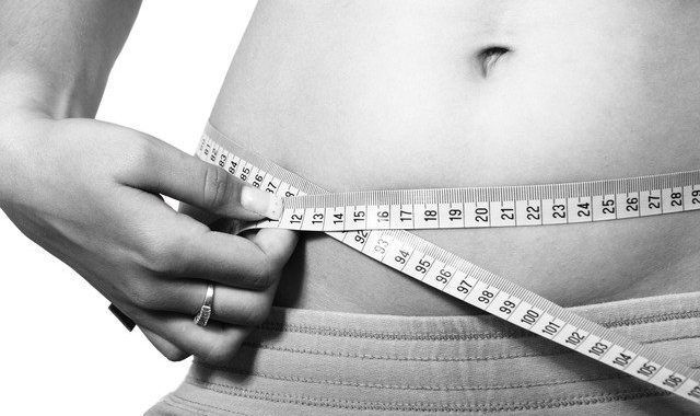 A Woman Is Measuring Her Waist - Columbia, SC - Custom Assurance Placements