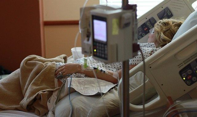 A Woman Is Laying In A Hospital Bed - Columbia, SC - Custom Assurance Placements