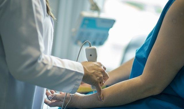 A Doctor Is Examining The Arm Of The Patient - Columbia, SC - Custom Assurance Placements