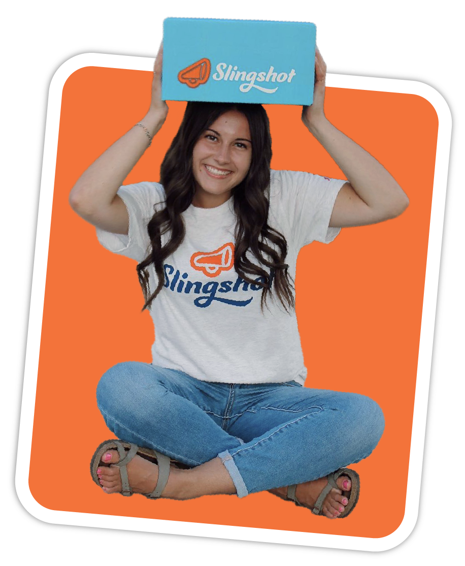 Student leaning on Slingshot box