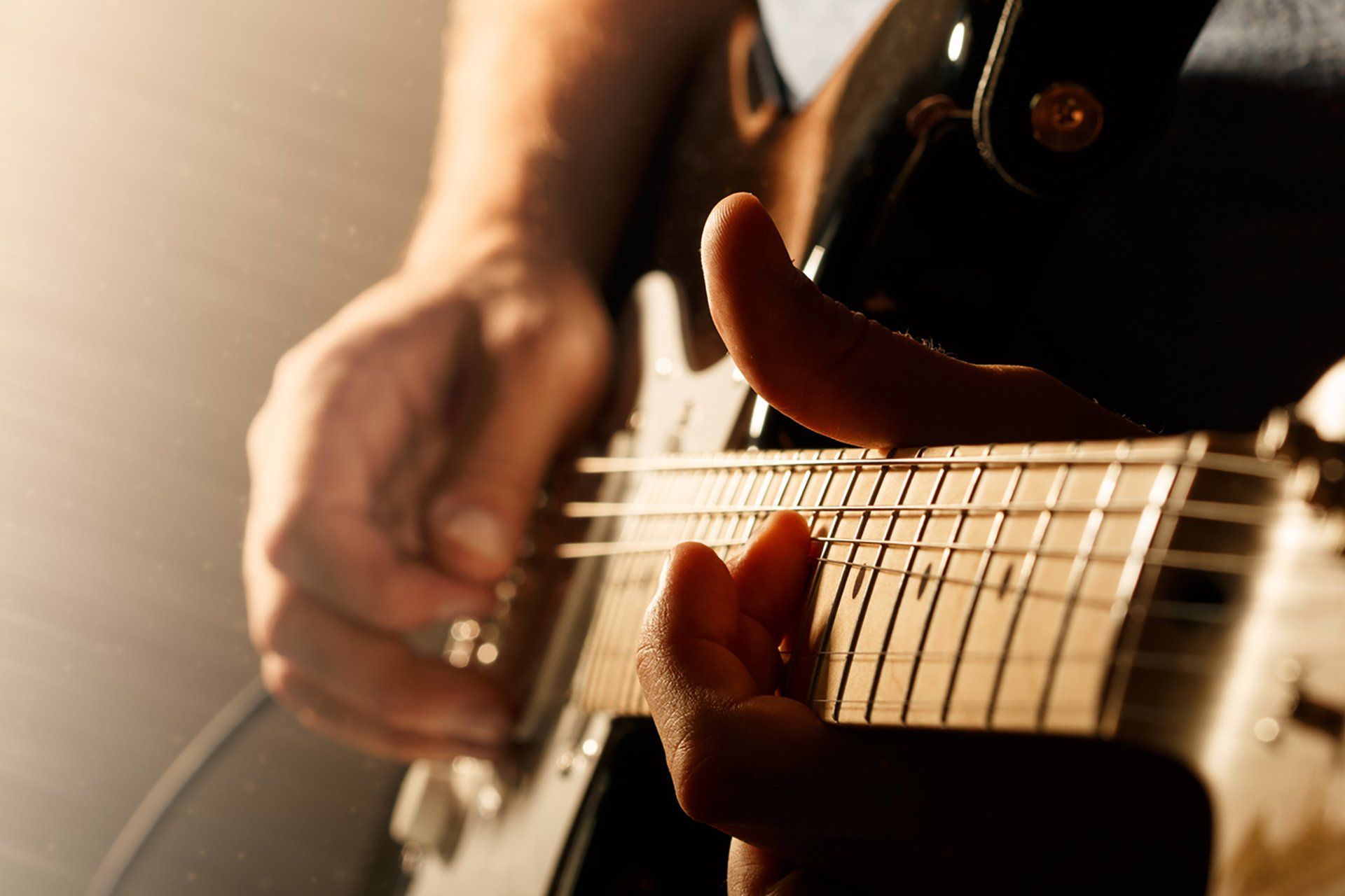 a close up of a person playing an electric guitar .