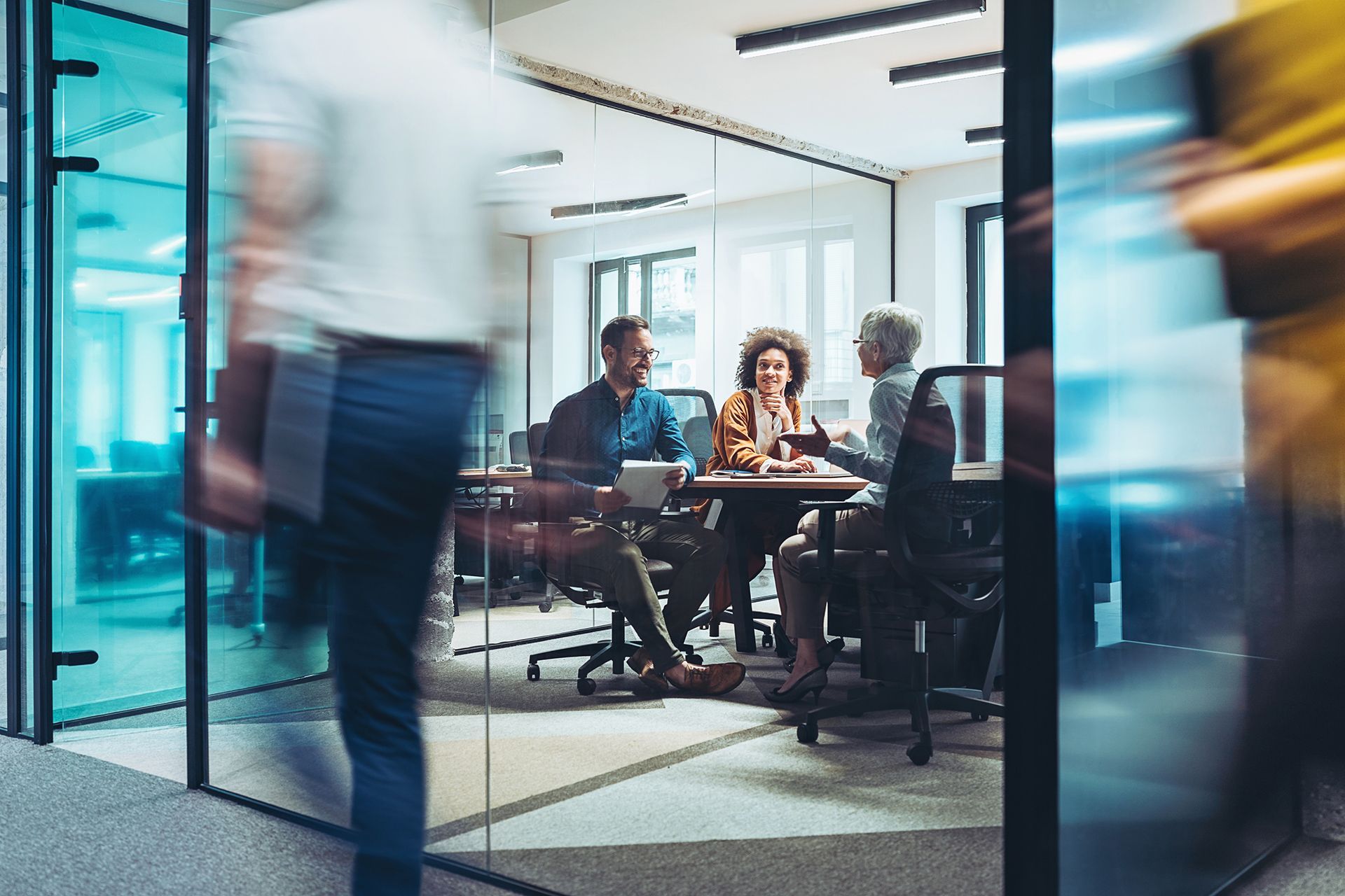 A group of people are having a meeting in a conference room.