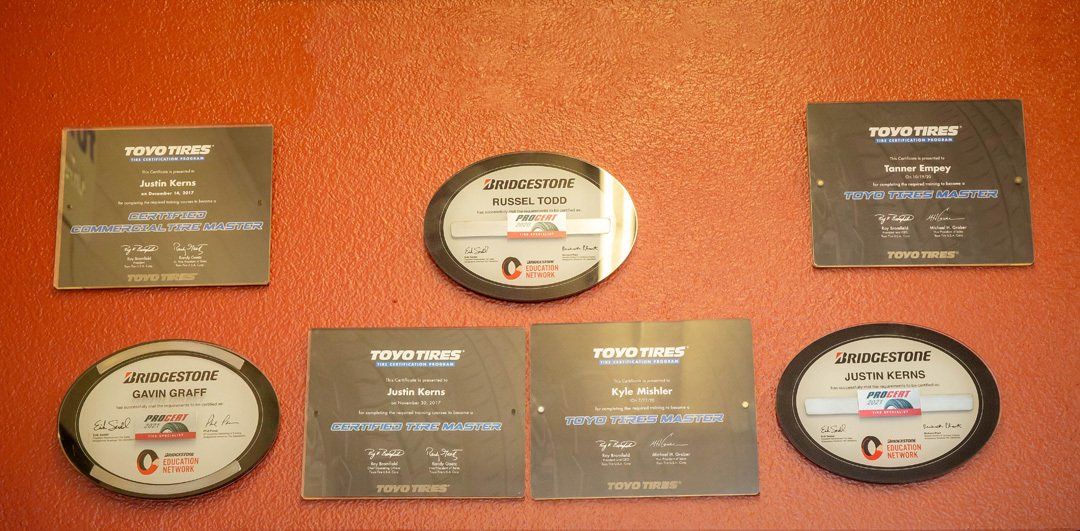 Six vintage audio cassettes and cases arranged on an orange surface.