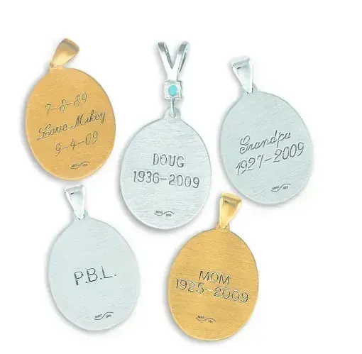Four memorial pendants in gold and silver with engraved names and dates.
