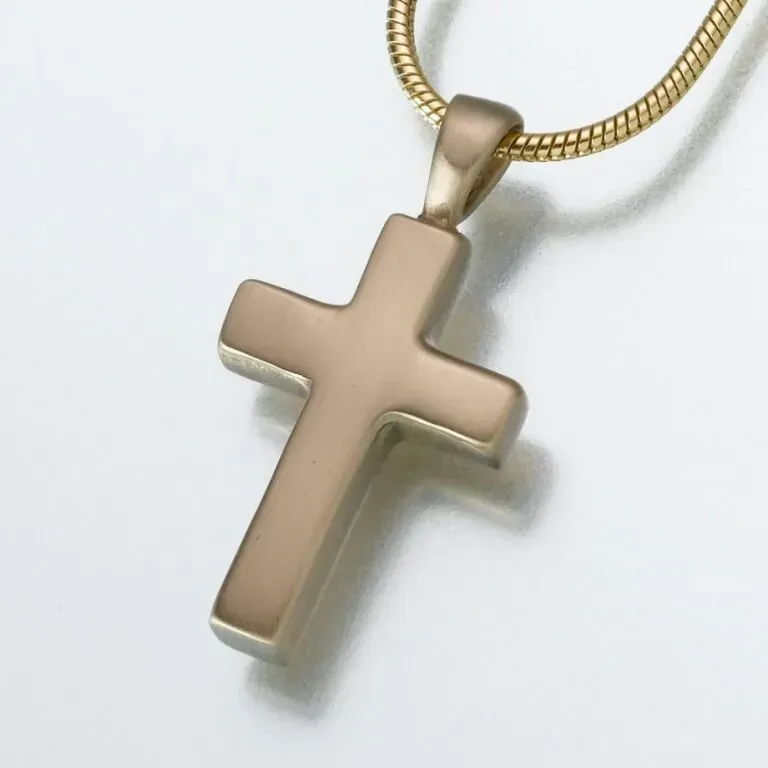 Gold cross pendant on a chain against a white background
