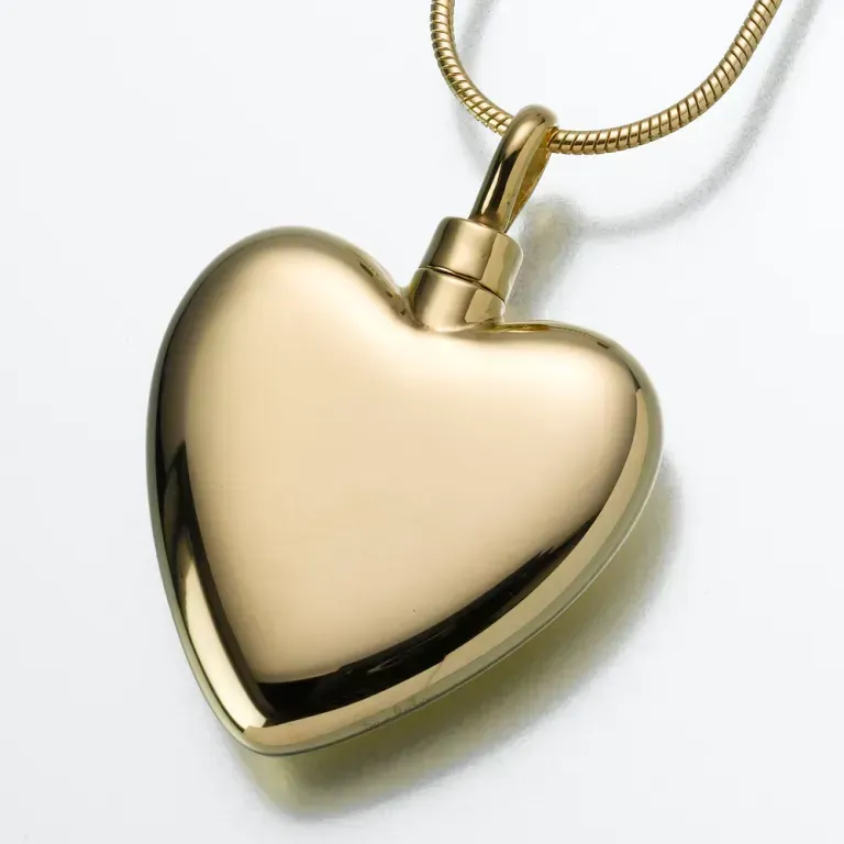Gold heart-shaped pendant necklace on a white background