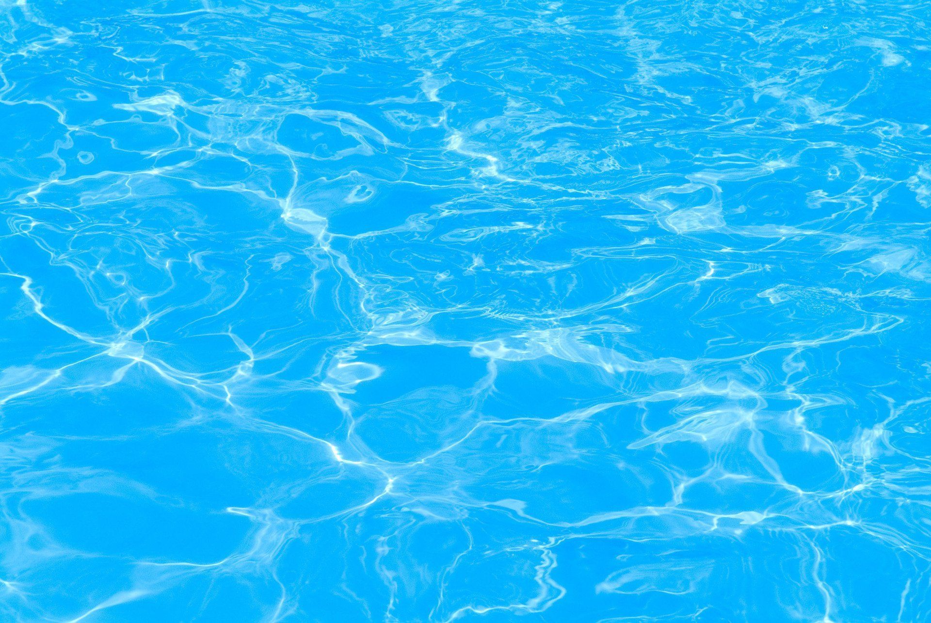 A close up of the water in a swimming pool.