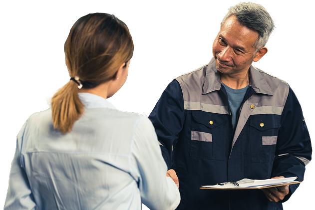 Woman in a light blue shirt shakes hands with a smiling man in a blue work uniform, holding a clipboard. | Madison Automotive
