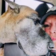 Faith receives loving affection from her fur baby, a tender moment that shows their beautiful bond.