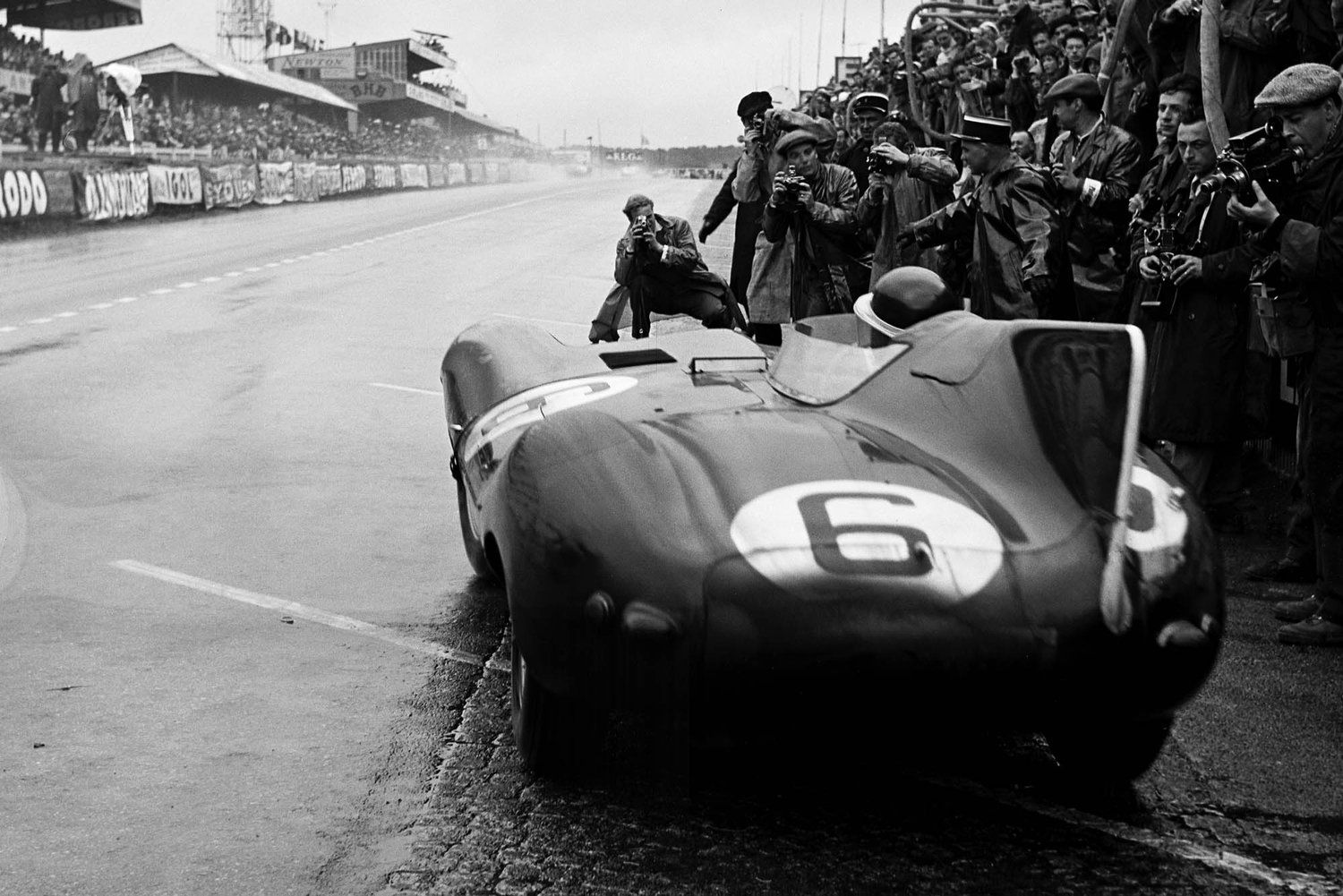 A black and white photo of a race car with the number 6 on the back
