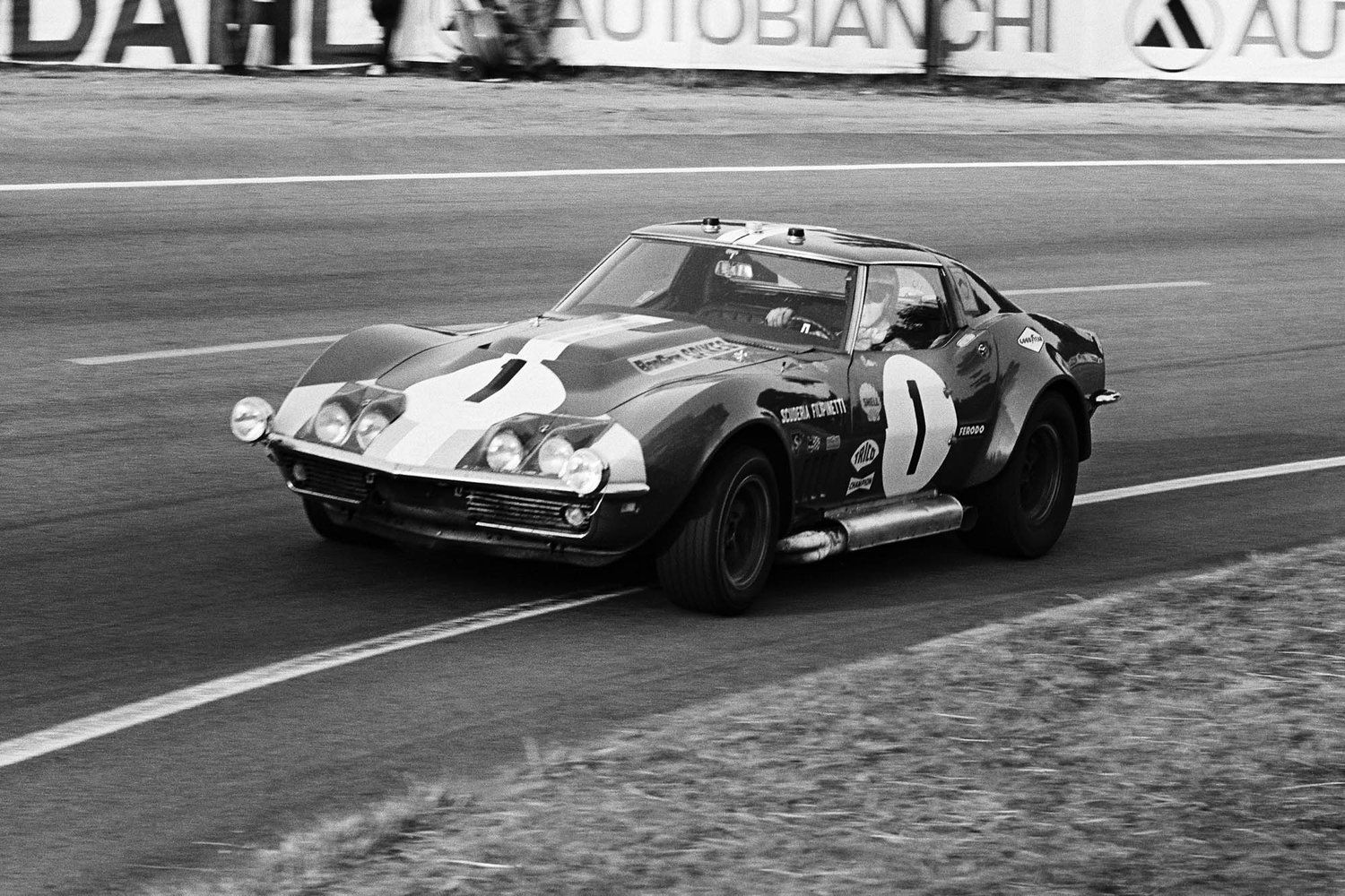 A black and white photo of a race car with the number 1 on it
