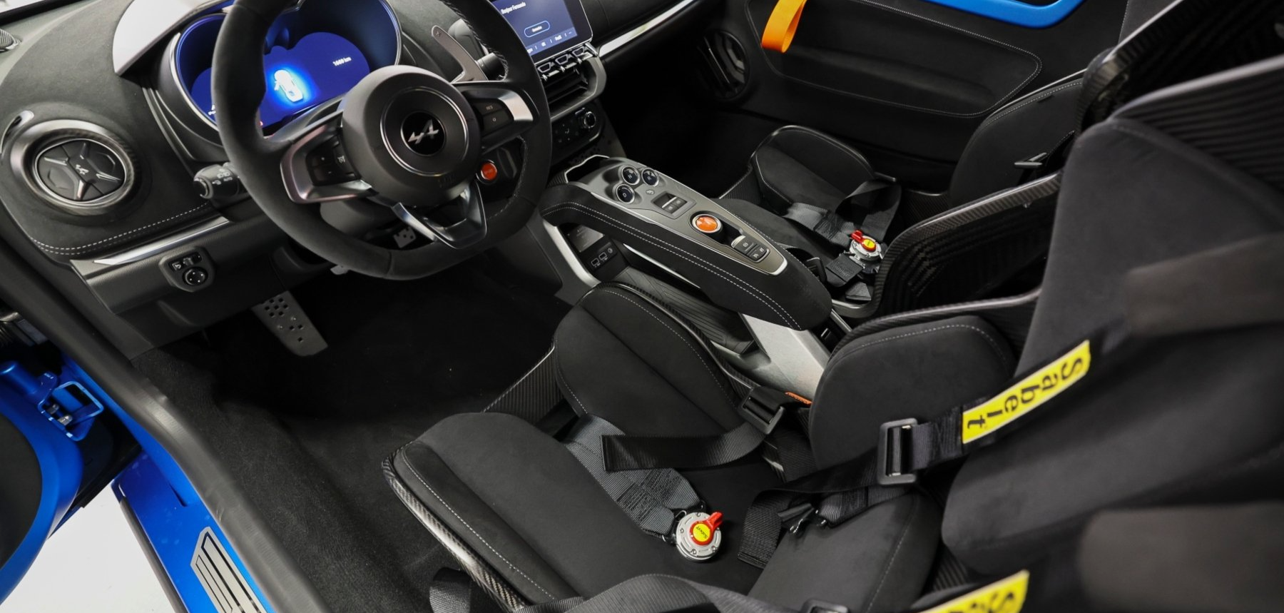 A close up of the interior of a race car with the door open.