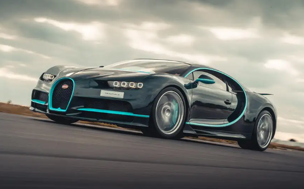 A bugatti chiron is driving down a road.