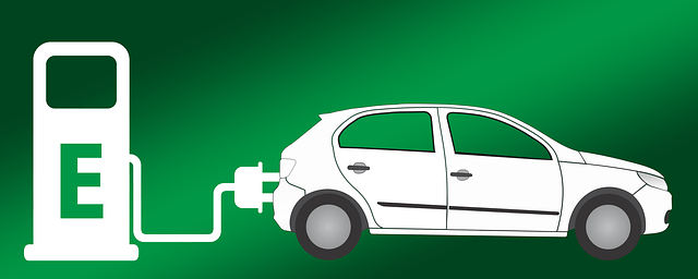 A white electric car is being charged at a charging station.
