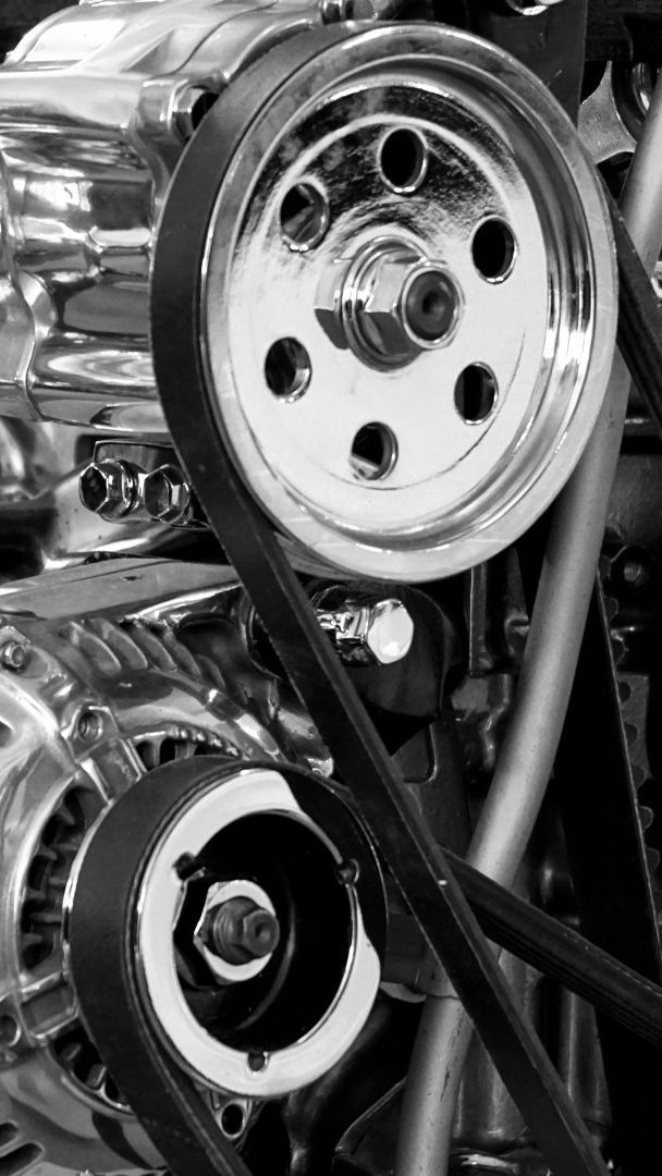 A close up of a belt on a car engine.