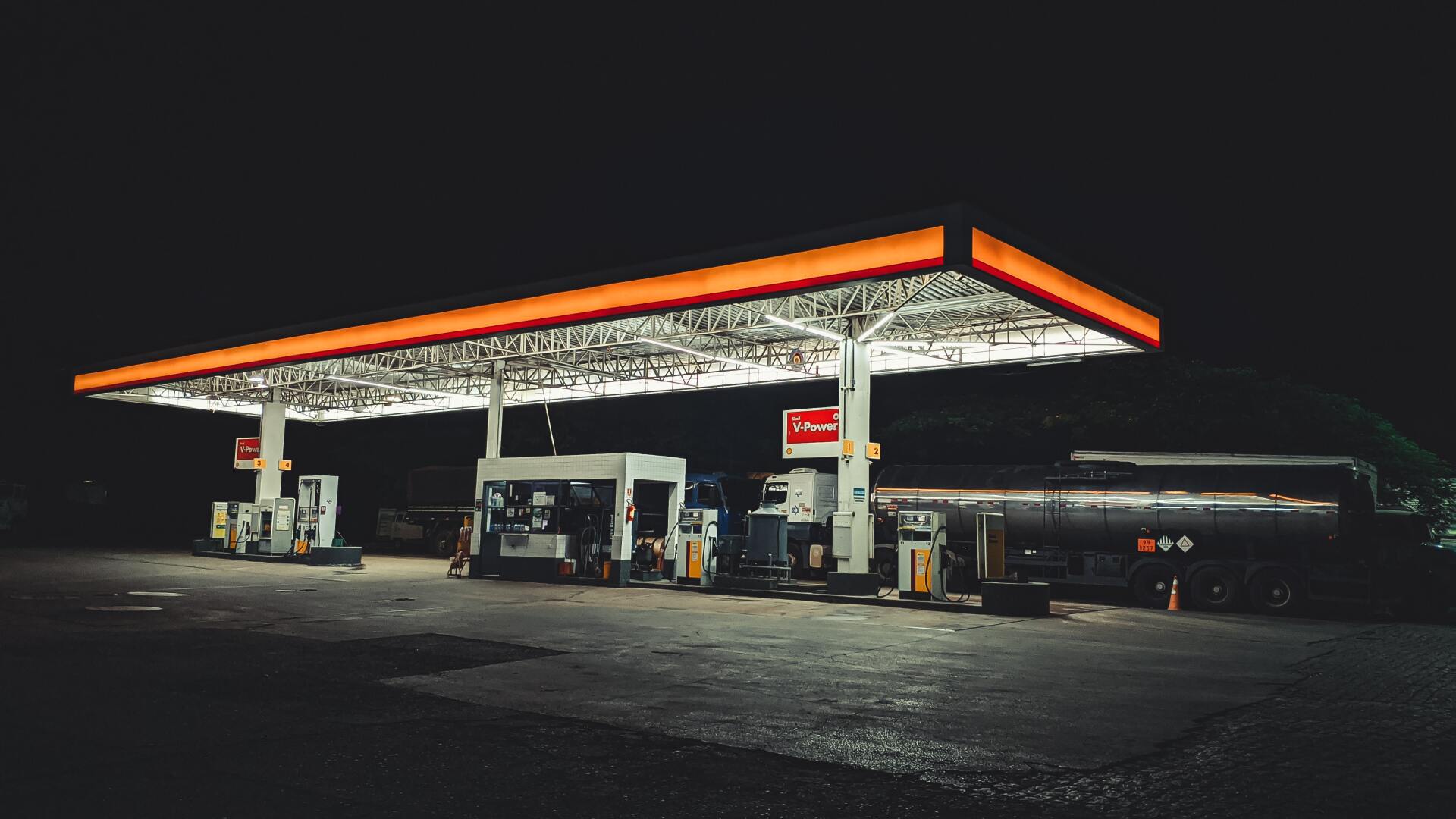 A gas station is lit up at night.