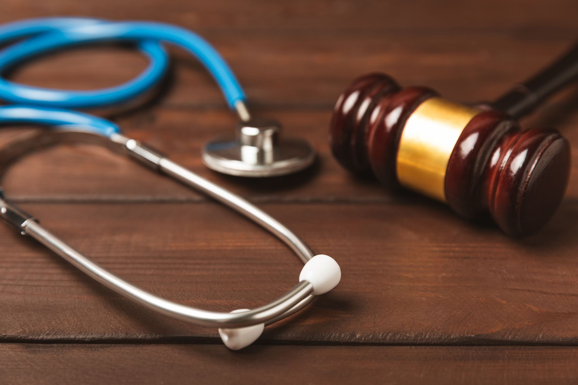 Personal injury legal concept with gavel and stethoscope on wooden desk. Personal injury legal concept with gavel and stethoscope on wooden desk.