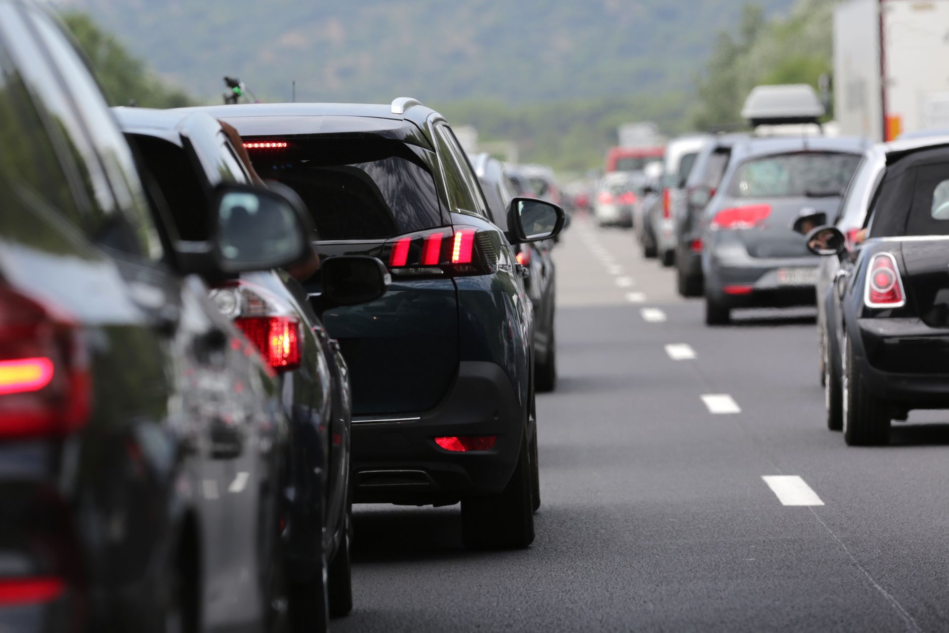 Cars navigating a busy road with traffic lights controlling the flow of vehicles. Cars navigating a busy road with traffic lights controlling the flow of vehicles.
