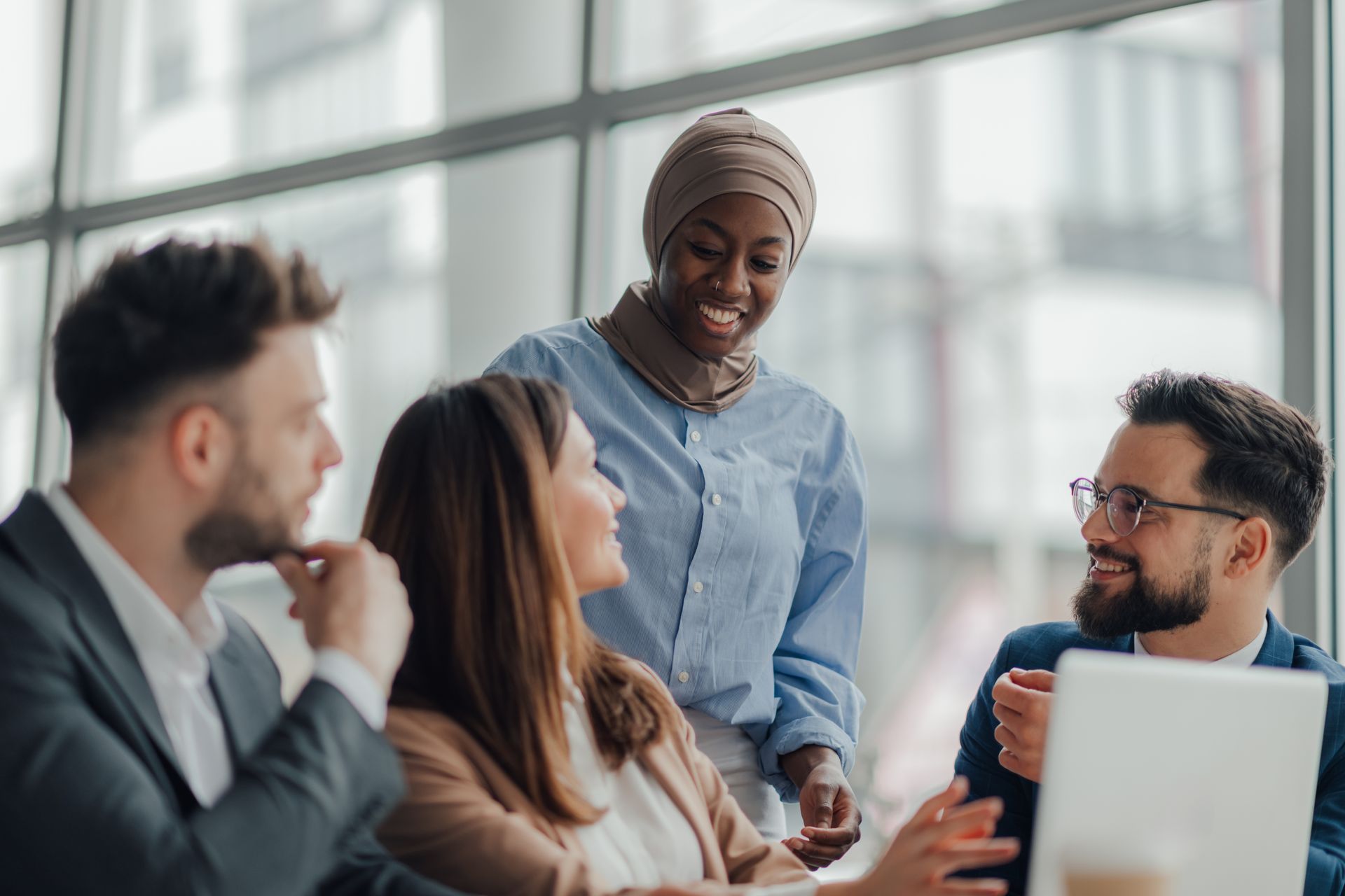 Four business colleagues collaborating around a table
