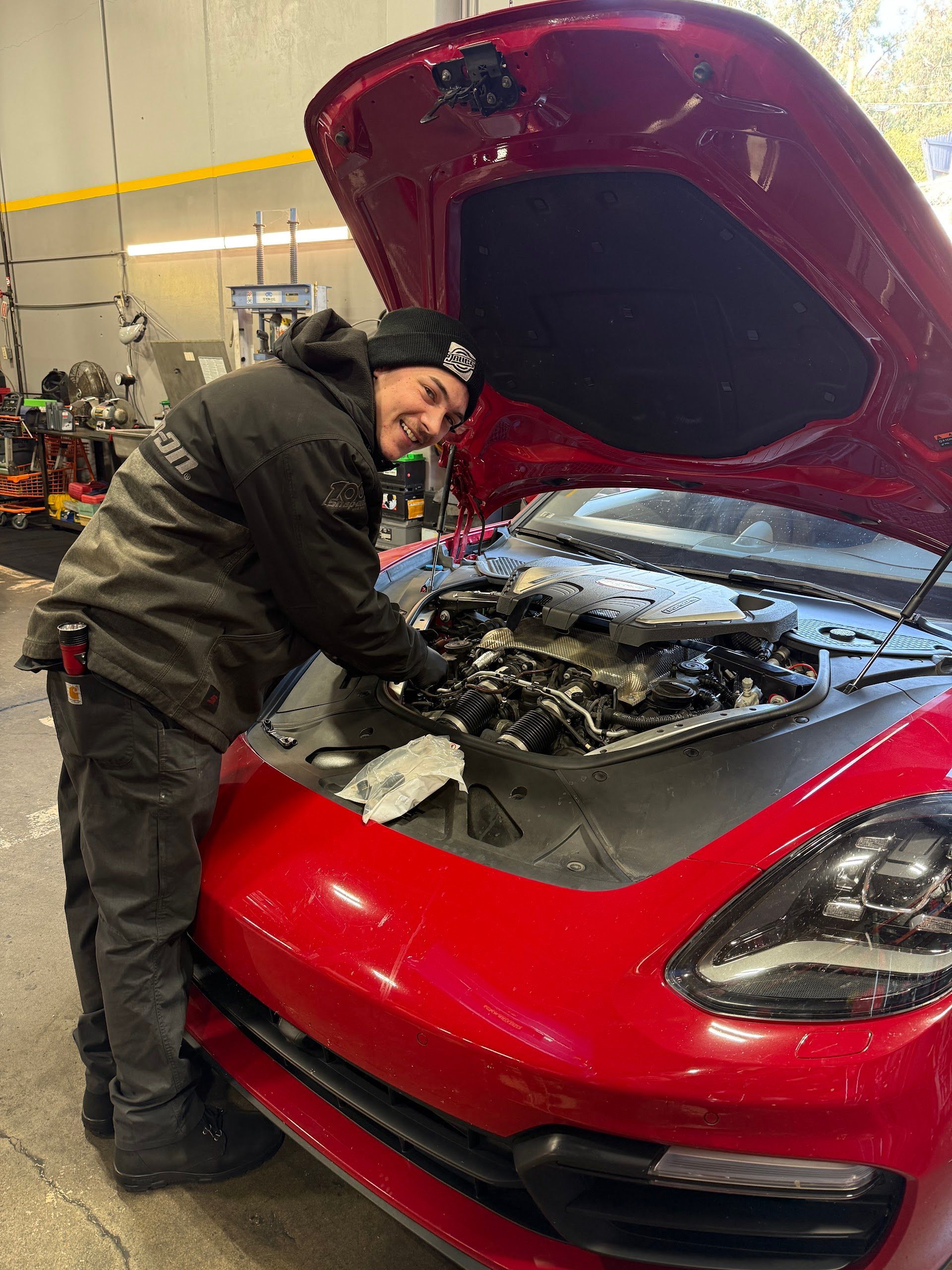 Technician Inspecting A Red Porsche Engine | German Autowerke