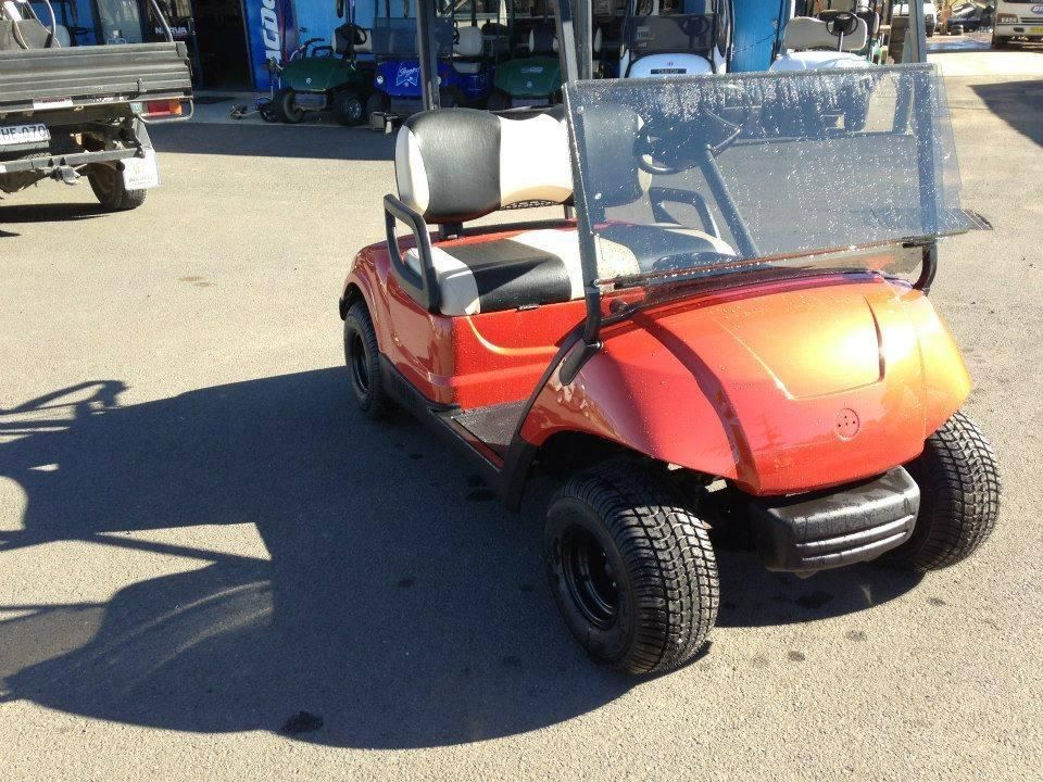 A Red Golf Cart Is Parked in A Parking Lot — DTM Tamworth in Tamworth, NSW