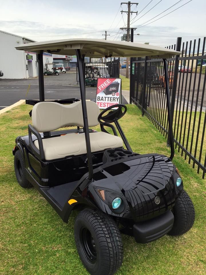 A Black Golf Cart Is Parked in The Grass Next to A Fence — DTM Tamworth in Tamworth, NSW