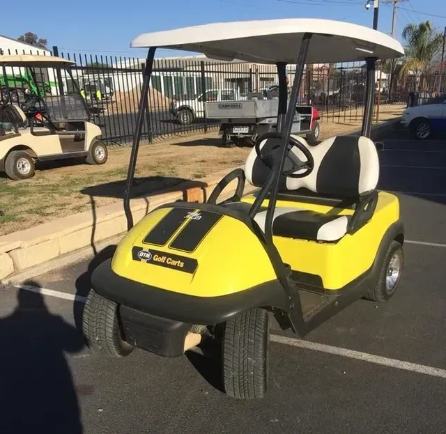 A Yellow Golf Cart Is Parked in A Parking Lot — DTM Tamworth in Tamworth, NSW