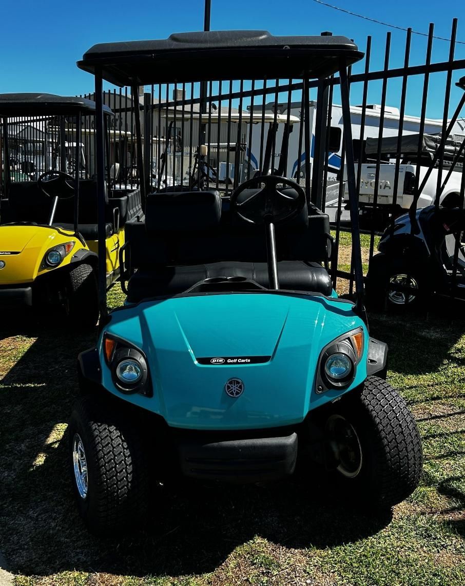 A Blue Golf Cart Is Parked in Front of A Fence — DTM Tamworth in Tamworth, NSW