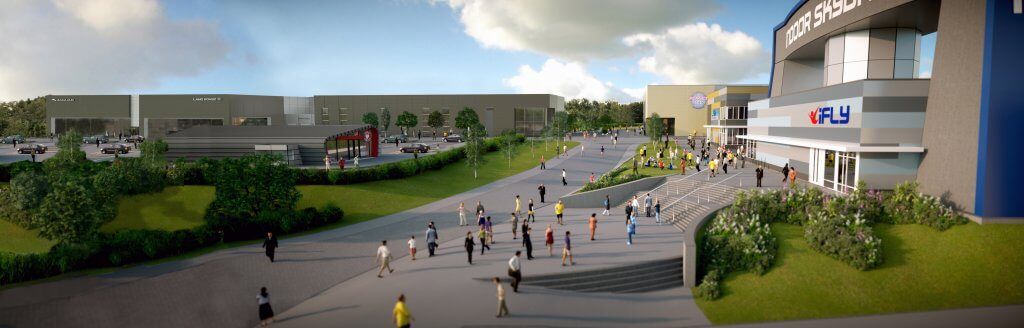 A group of people are walking down a sidewalk in front of a large Reidsteel building.