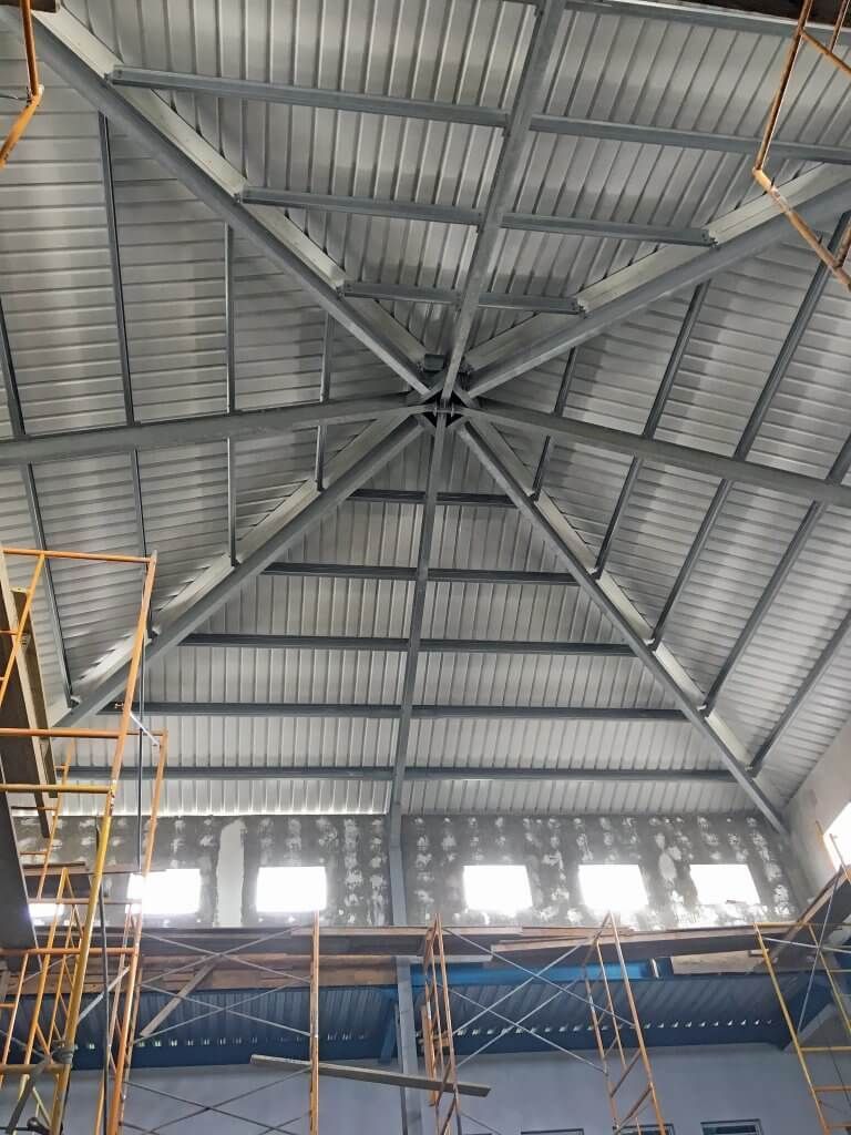 The ceiling of a Reidsteel building under construction with scaffolding around it.