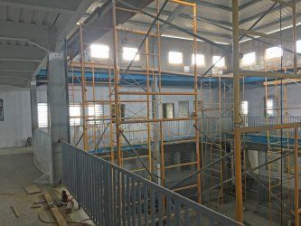 A Reidsteel building under construction with scaffolding and stairs.