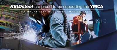 A man in a wheelchair is welding a piece of metal.