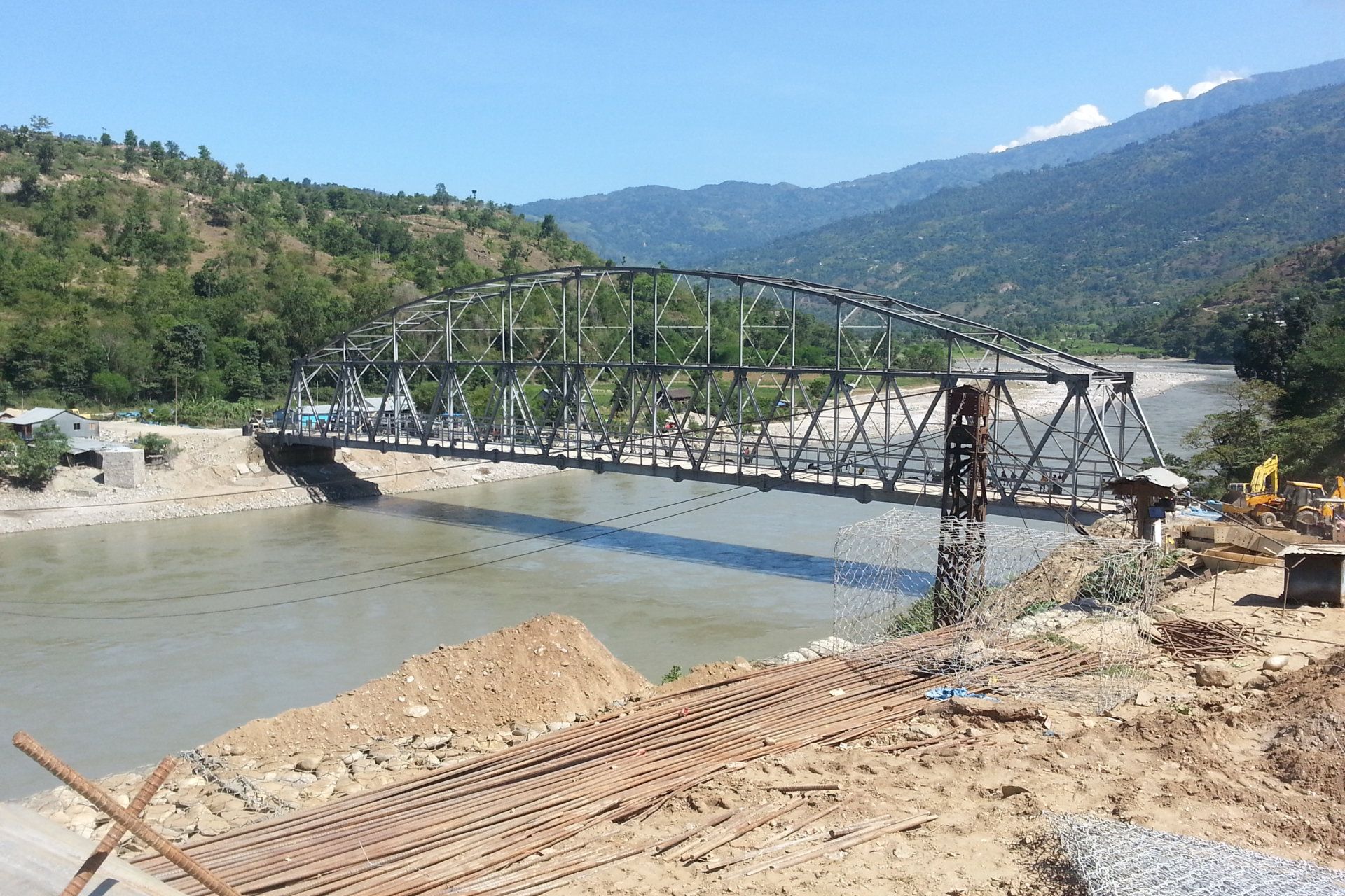 A bridge over a river with mountains in the background