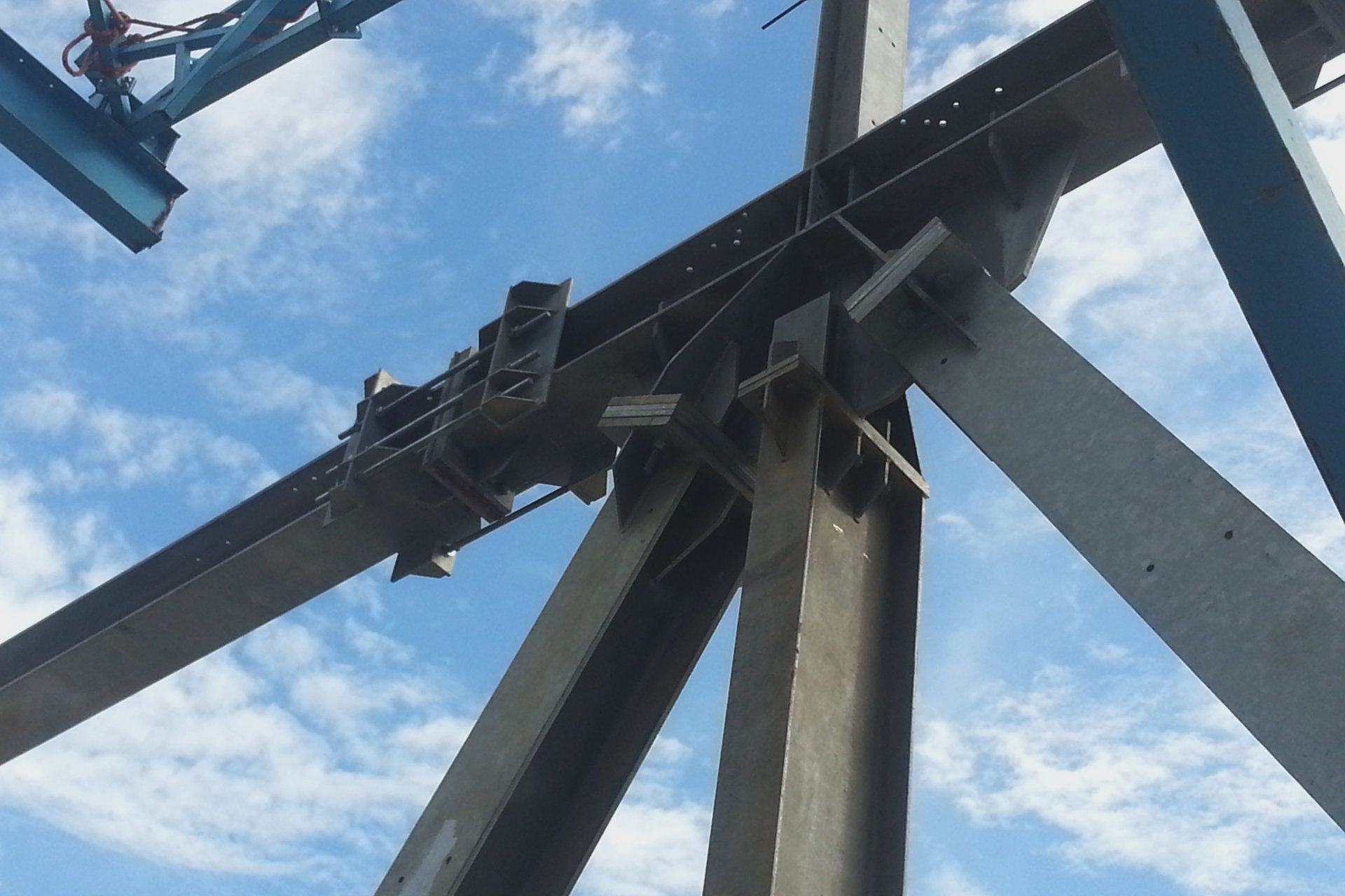 A large metal structure with a blue sky in the background
