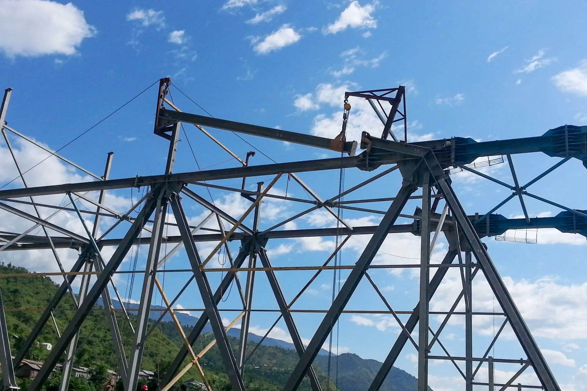 A large metal structure with a blue sky in the background