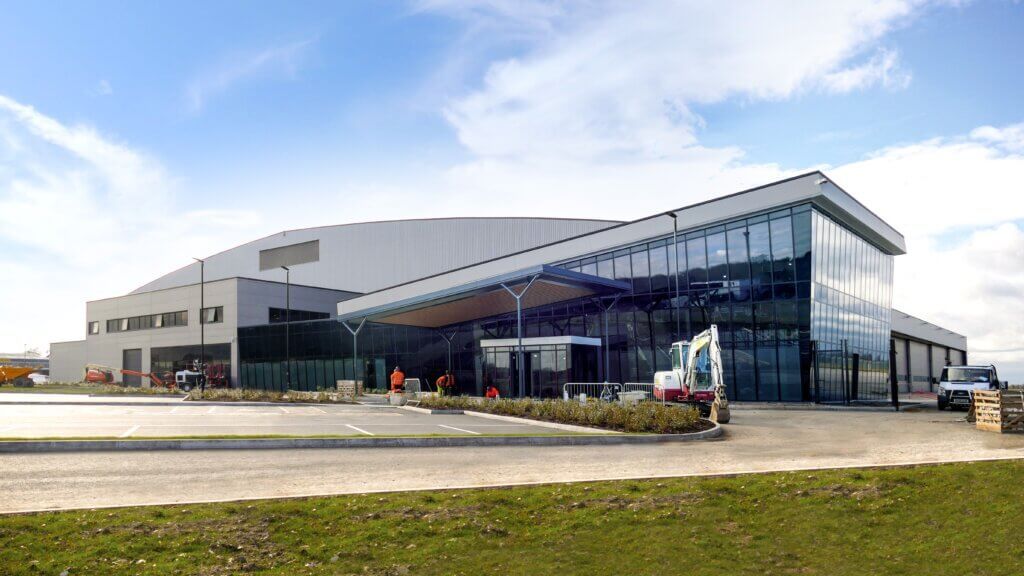 A large Reidsteel building with a lot of windows and a truck parked in front of it.