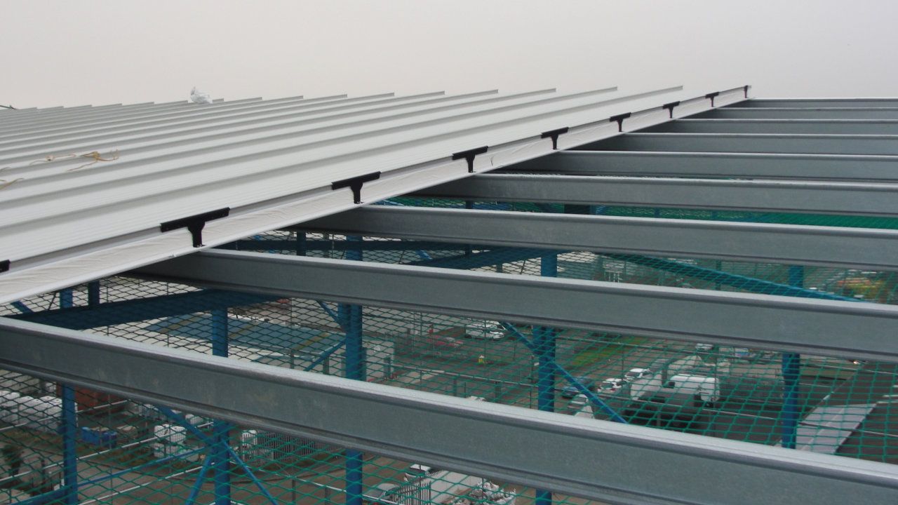 A close up of a metal structure with a roof.