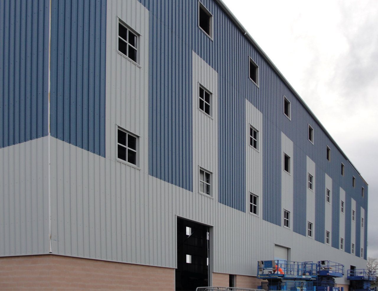 A large building with a lot of windows and a large door